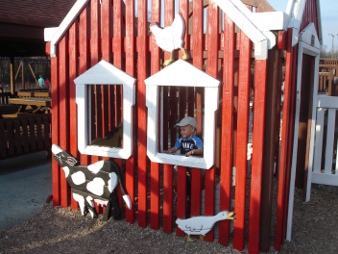 I played in the barn. Mommy is in there with me. She is lifting me up so I can look out the window.